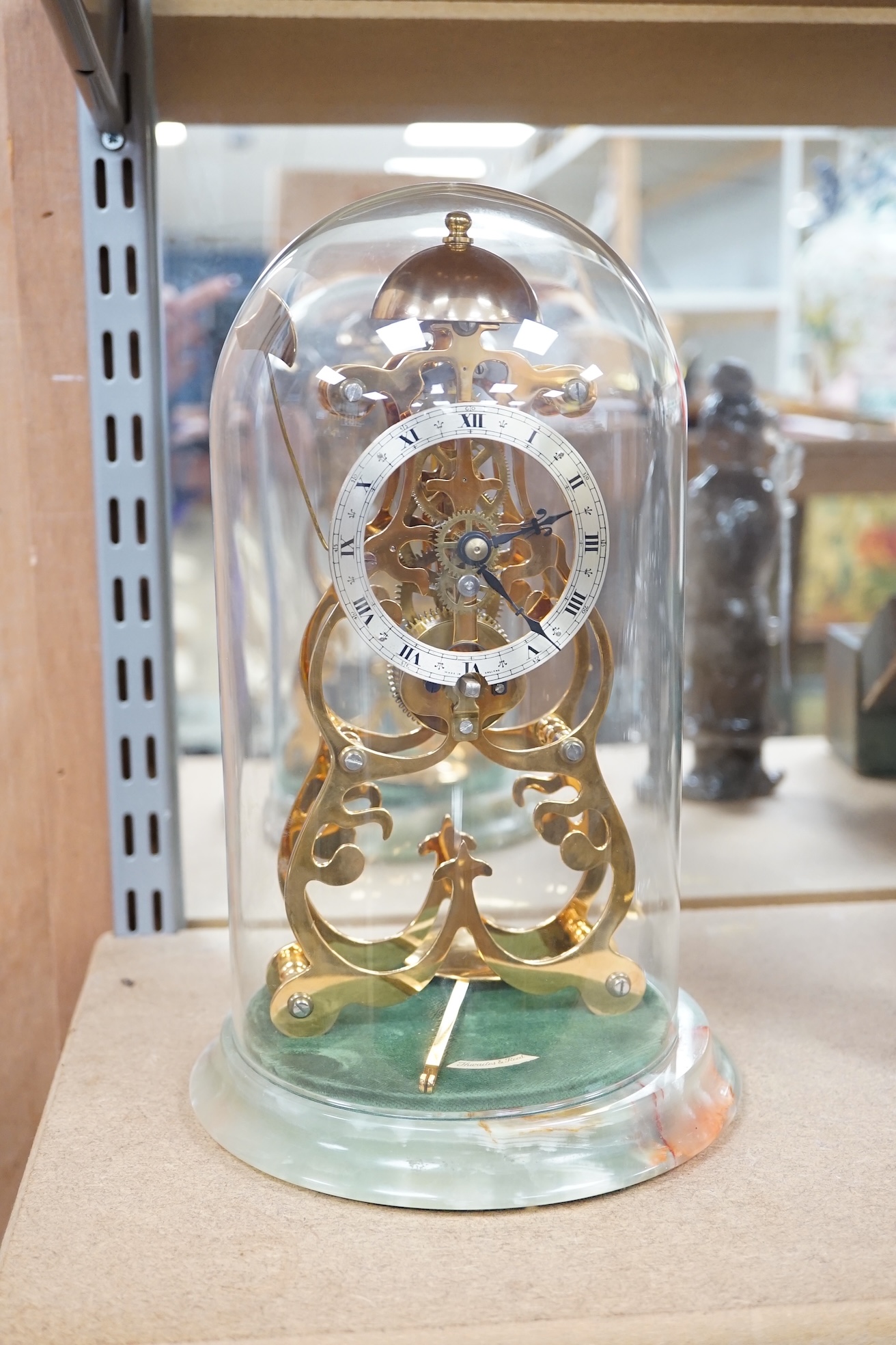 A Thwaites & Reed brass skeleton clock under dome, on onyx base, 27cm. Condition - good, not tested